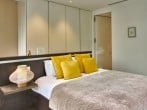 Bed with yellow cushions